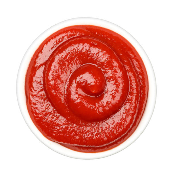 istock Swirling ketchup in a small white bowl on white background 2185458916