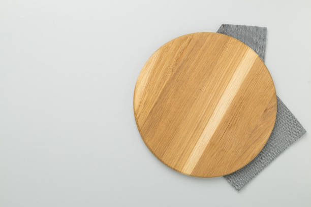 istock Cutting board with napkin on color background, top view 2185458919