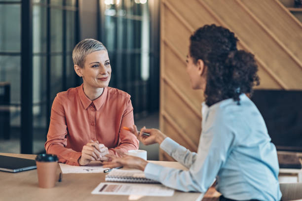 istock Two females coworker talking 2185459939
