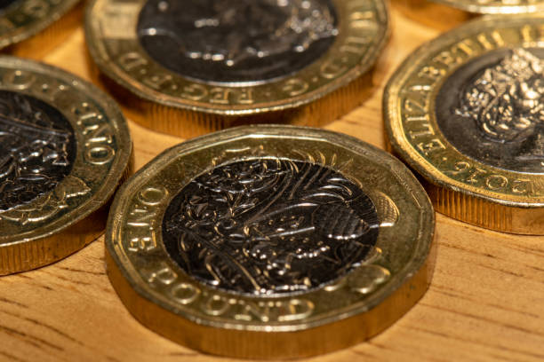 istock Close-up of Multiple British One-Pound Coins on Wood 2185460895