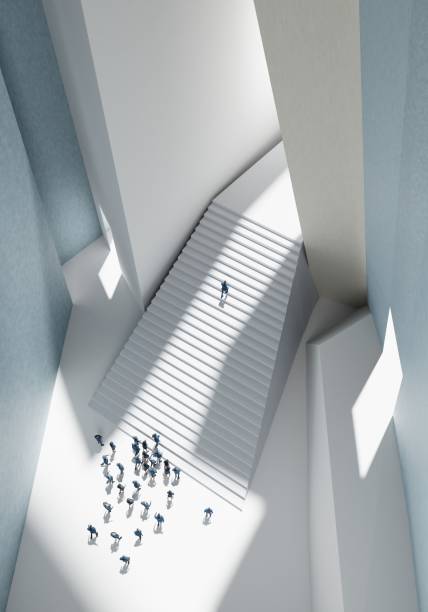 istock Business people watching a man climbing up stairs. Abstract environment with massive stairs representing a startup, growth, career and positive progressing concept 3d rendering 2185463697