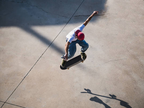 istock A skateboarder executes a high jump trick on concrete surface 2185465324