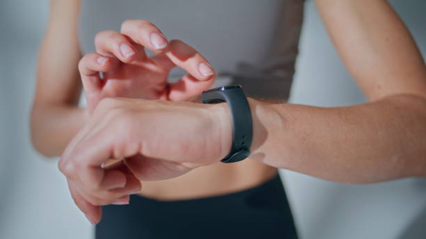 istock Hands touching smart watch closeup. Sportswoman tapping screen display indoors 2185470134