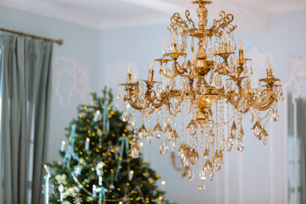 istock Elegant chandelier illuminated above a beautifully decorated Christmas tree 2185473669