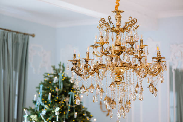 istock Elegant chandelier illuminating a festive space with a Christmas tree 2185473672