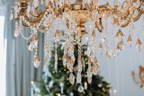 istock Elegant chandelier adorned with crystals over a festive Christmas tree 2185473688