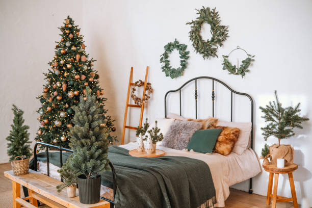 istock Cozy bedroom decorated for Christmas with a tree and greenery in winter 2185473713