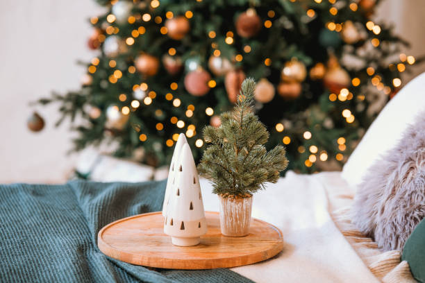 istock Cozy bedroom with Christmas decorations and a small tree on a nightstand 2185473723