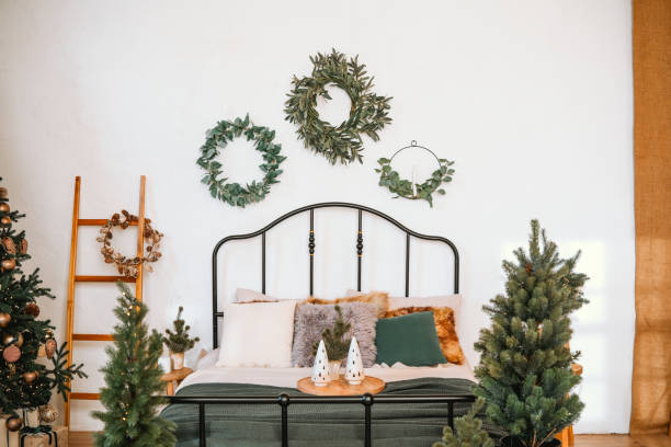 istock Cozy winter bedroom decorated with greenery and festive details 2185473740