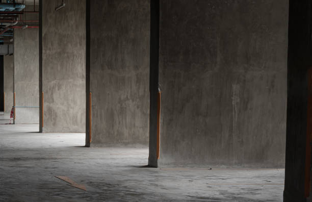 istock Sun rays light shining through Grungy concrete plaster cement wall and Floor. 2185474901