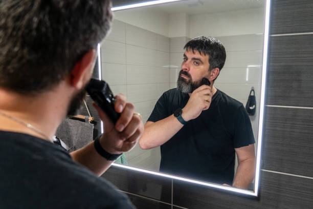 istock Man shaving his beard in the bathroom. Beard care, electric razor. 2185475210