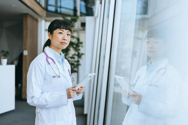istock Thoughtful doctor with reflection in glass 2185476529