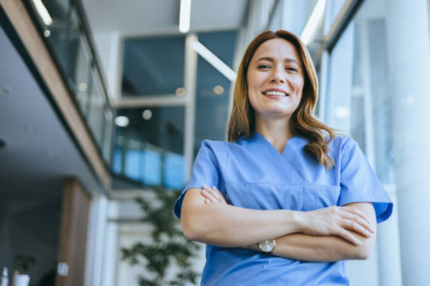 istock Cheerful nurse in a blue uniform smiling 2185476530