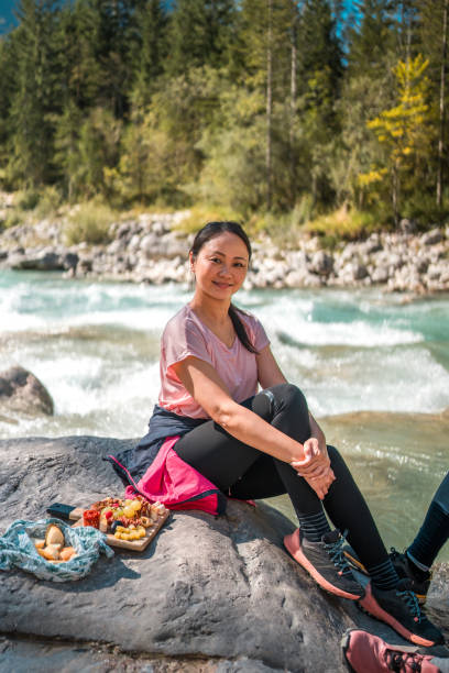 istock Asian Female Hiker Resting by Mountain River 2185477150
