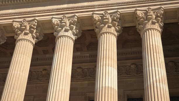 istock Ornate Corinthian columns with intricate floral capitals support a grand stone facade, highlighting classical architectural elegance and detail. 2185477325
