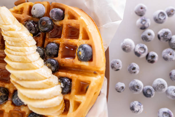 Delicious waffle with banana, blueberries and maple syrup from a coffee truck