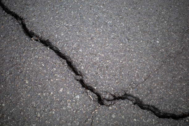 istock Asphalt cracks, road surface damage due to earthquake in Indonesia 2185479082