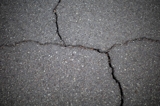istock Asphalt cracks, road surface damage due to earthquake in Indonesia 2185479169