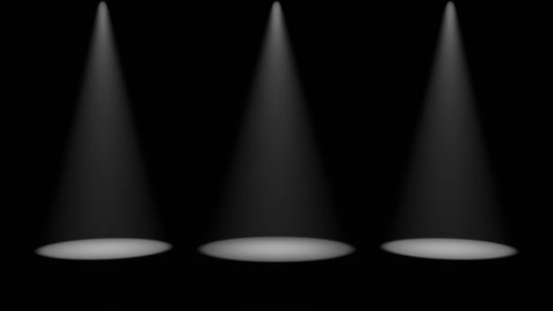 istock Three aligned spotlights illuminate a dark stage, creating a dramatic and mysterious effect 2185480524