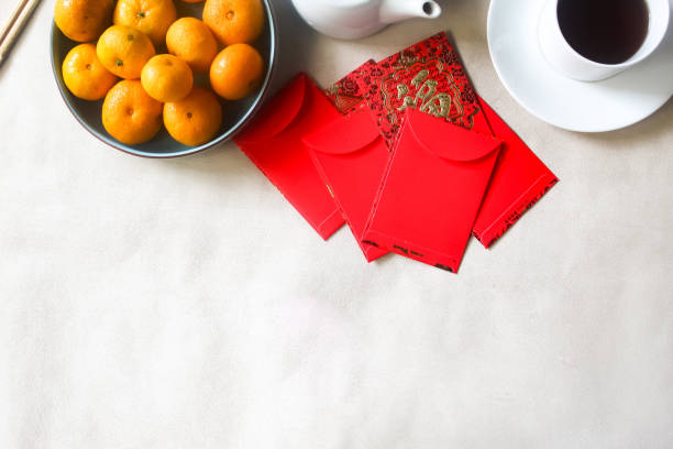 istock chinese new year decorations like mandarin oranges, red envelopes with negative space 2185483776