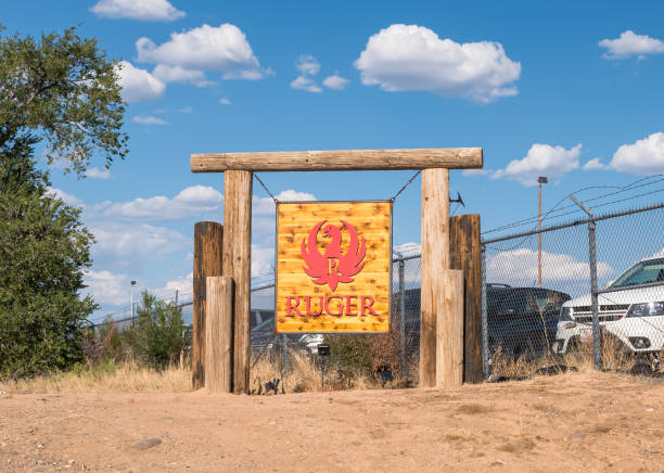 On the company grounds, the sign for Ruger Firearms in Prescott, Arizona, USA Prescott, Arizona, USA September 4, 2024 The Ruger Firearms sign on the company grounds on a sunny summer day wood and wire fence designs pictures stock pictures, royalty-free photos & images