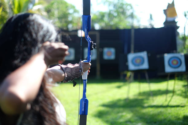 Children's birthday party with archery and arrow feathers in the foreground