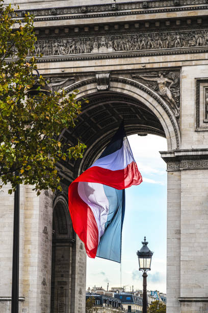 istock Paris : large French flag flying under the Arc de Triomphe. 2185494356
