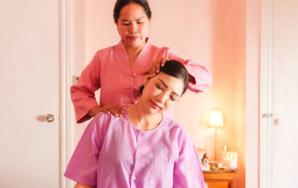 istock Therapist helping a woman stretch neck with cervical therapy. 2185497190