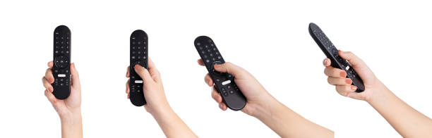 Hand holding television remote isolated on white background, clipping path.