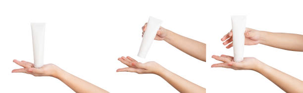 istock Female hand holding blank cosmetic bottle isolated on white background, clipping path. 2185497317
