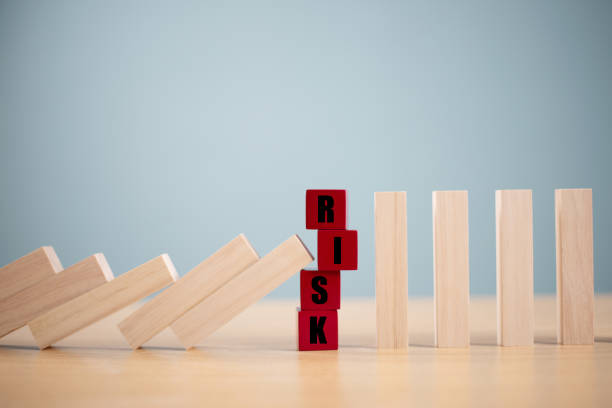 istock Risk management crisis concept. Financial analysis solution, real estate business. Stop economic risk assessment. Risk word on wooden block, domino crisis reduce effect. Insurance security assessment 2185498803