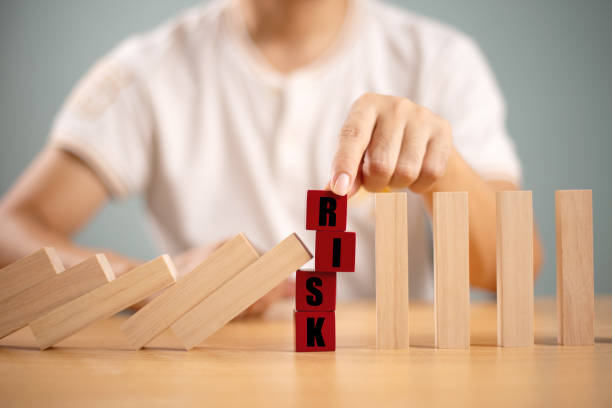 istock Risk management crisis concept. Financial analysis solution for real estate business. Hand stop economic risk. Risk word on wooden block, domino crisis reduce effect. Insurance security assessment 2185498804