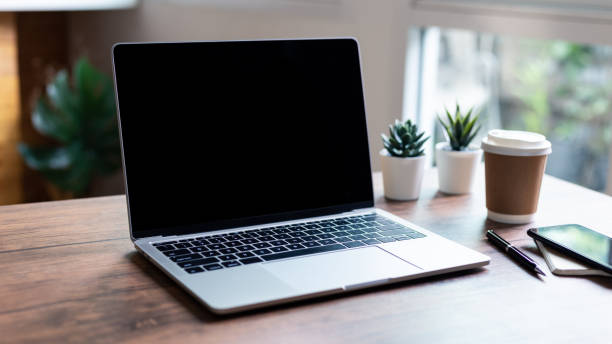istock mock up empty screen computer on wood desk in home 2185499274
