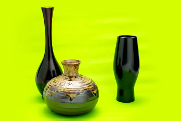 set black antique ceramic vase. empty decorative ceramic pot on green background. brown modern porcelain vase for room interior. vintage handmade glaze pottery flowerpot office decoration collection
