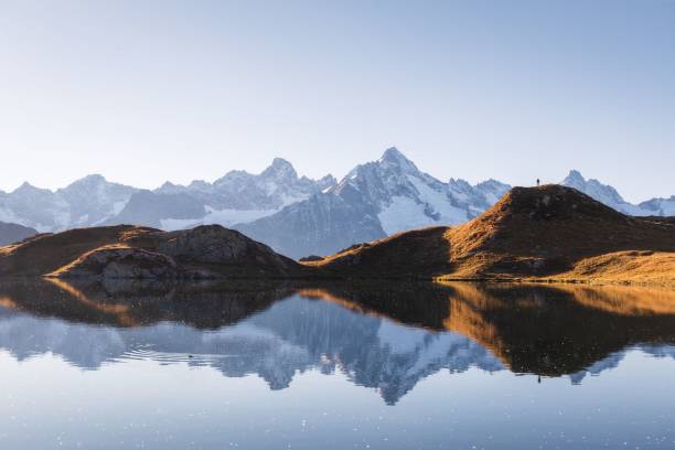 istock Autumn landscape view of a mountain range reflecting in a lake 2185502980