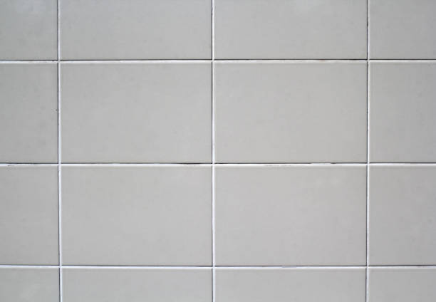 istock White tiles wall close-up abstract textured background 2185503094
