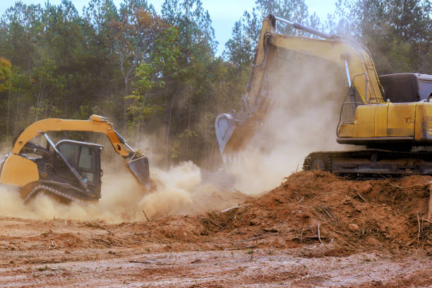 istock Heavy machinery bulldozer excavator working clearing land in forested area during daylight 2185504144