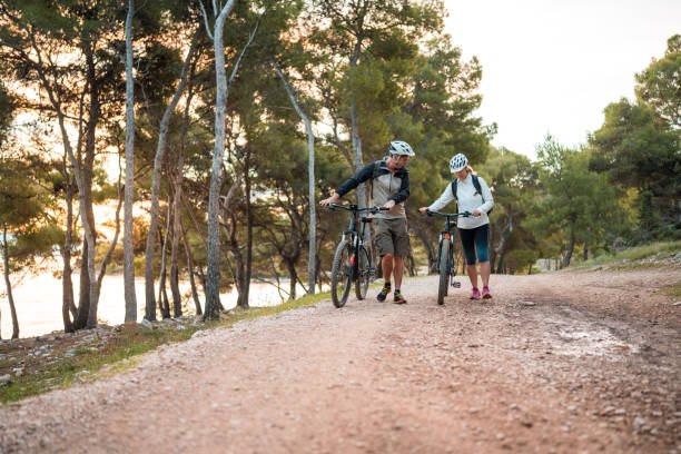 istock Active Senior Couple Prepares for Sunrise Seaside Cycling 2185505375