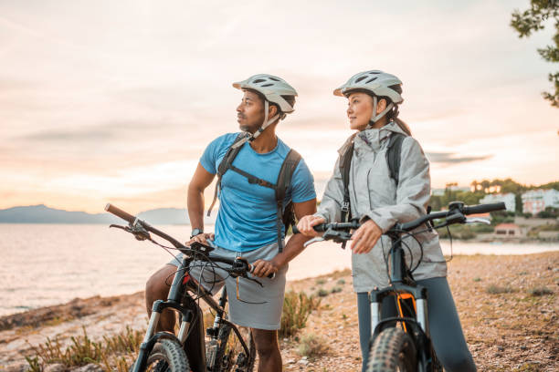 istock Active Diverse Couple with E-Bikes at Dawn by the Sea 2185505398