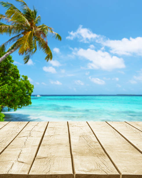 istock Empty wooden table top with beautiful paradise beach background 2185505744