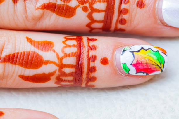 Hands of a young woman. The nails are covered with blue gel polish. Manicure ideas, winter-spring 2021.