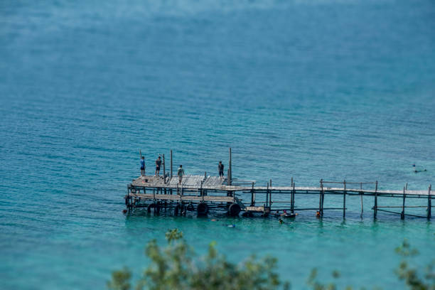 Wooden pier on the shoreline with a shift in slope