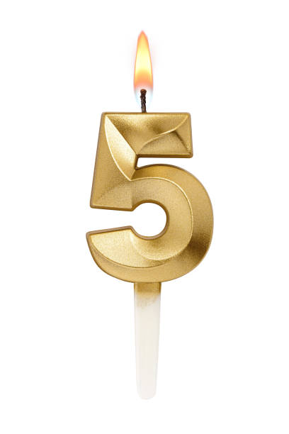 istock Golden decorated burning birthday candle digit five shaped isolated on white. 2185508714