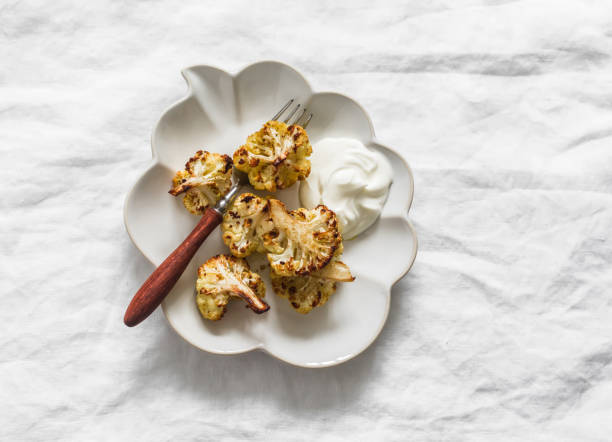 istock Baked cauliflower with Greek yogurt on a light background, top view 2185508841