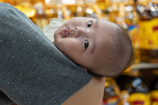 Mother shopping with baby in her arms