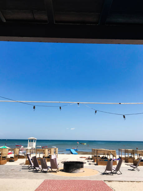 Relaxing beachfront view with lounge chairs and clear blue sky