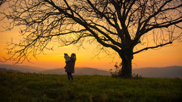 istock Caucasian Mother and Son Bonding in Sunset Field 2185513956