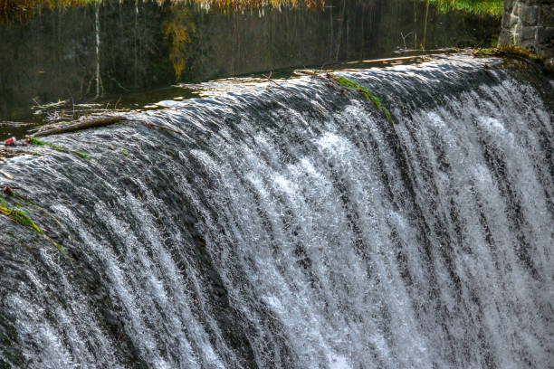 High water level on the Vistula River, water falling from the waterfall