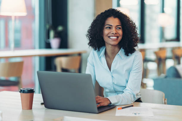 istock Smiling businesswoman using laptop in the office 2185515695