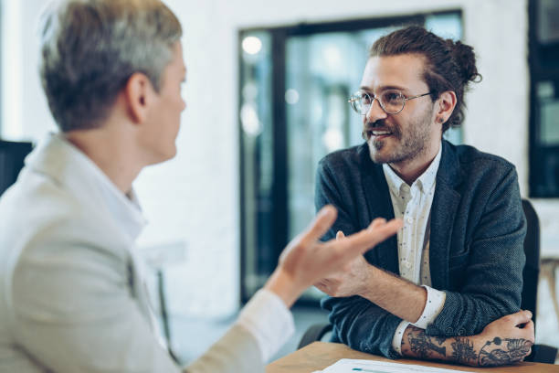 istock Couple of business persons discussing work 2185515698